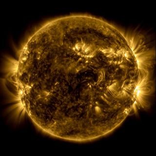 a yellow sun spews out flares and magnetic loops around its bulbous, burning body.