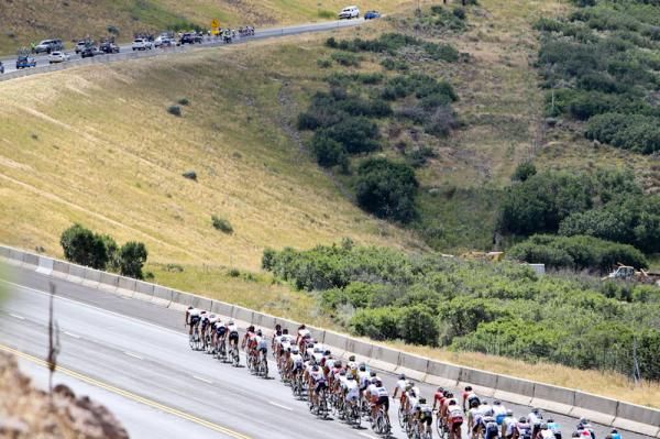 A break gets up the road in the distance first thing in the morning as the peloton chases.