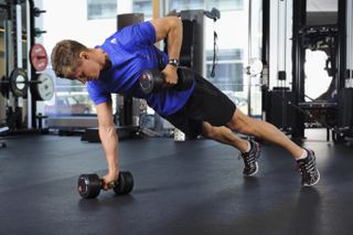 Man doing renegade rows with dumbbells