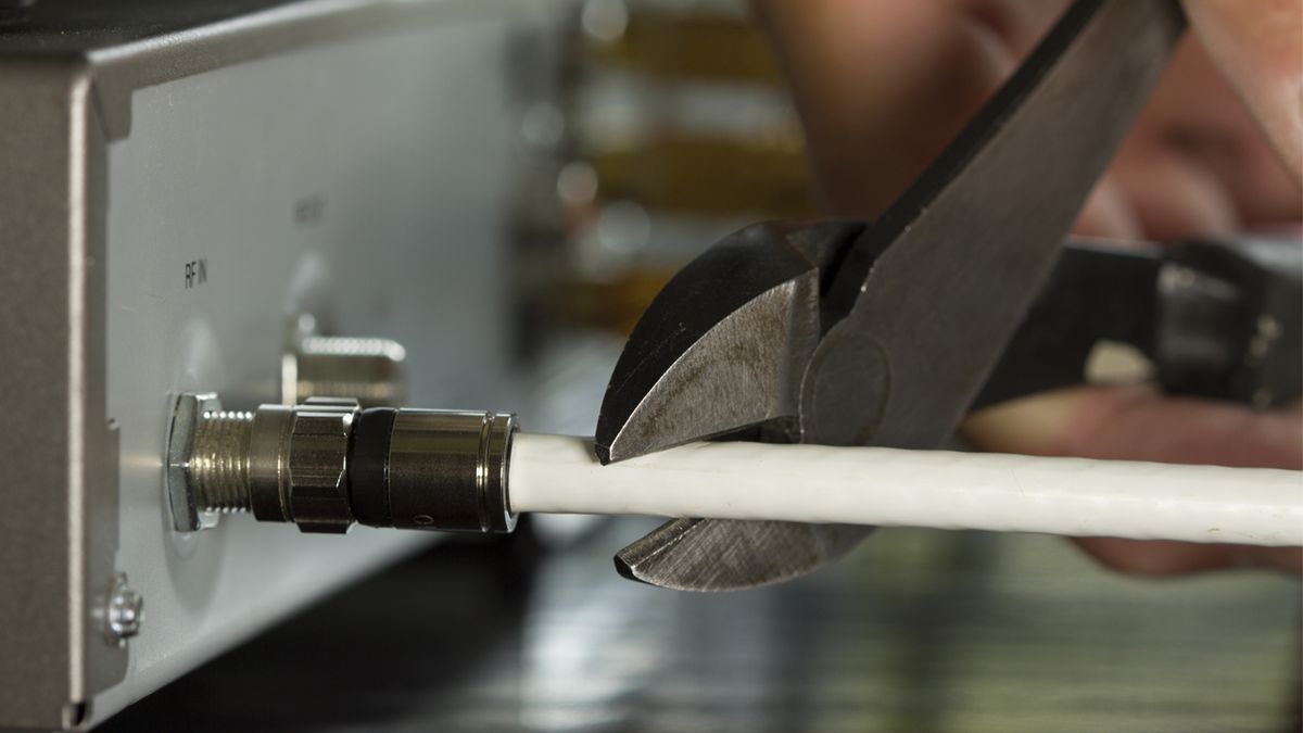 A pair of pliers cutting a cable cord