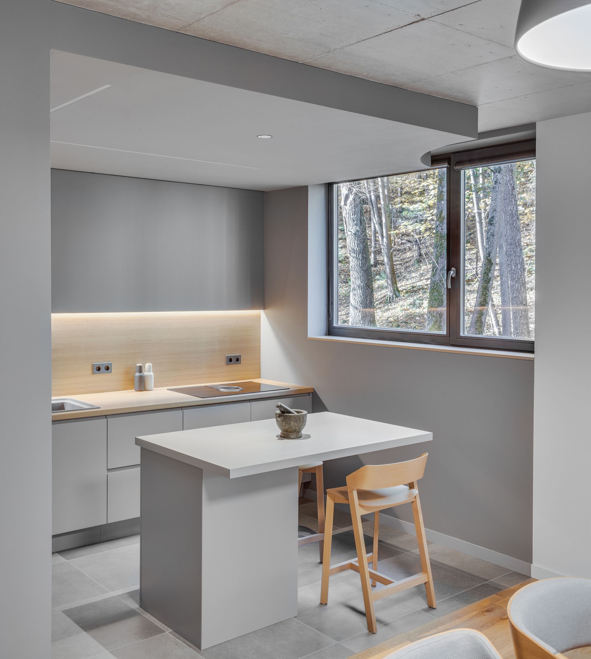 A wooden kitchen backsplash in an all-white kitchen