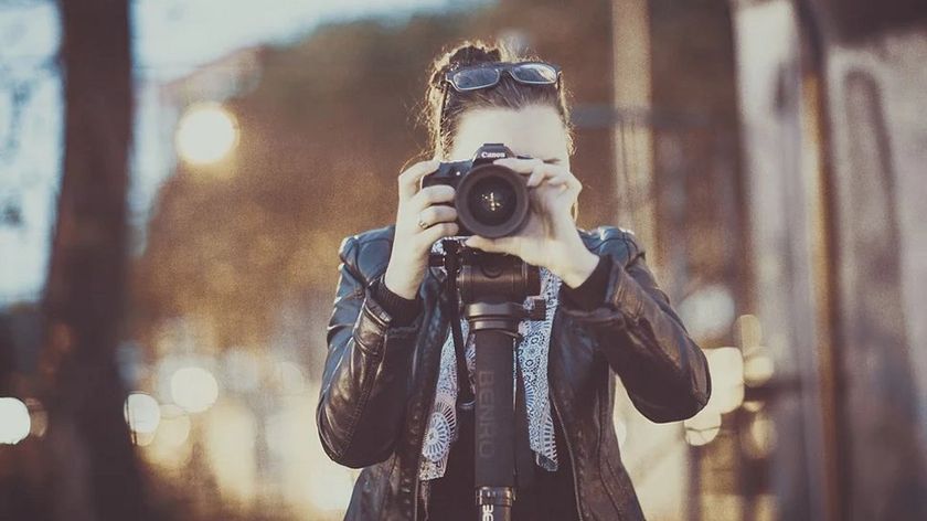 A photographer taking a photograph at the camera.