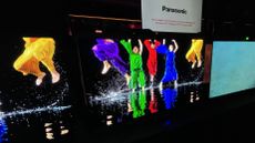 Panasonic Z95B OLED TV showing image of people in colorful clothes dancing