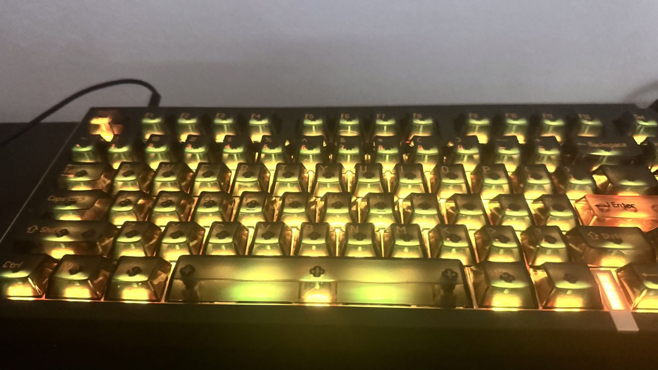 Melgeek Real 81 gaming keyboard on a desk, from the front, showing off its RGB lighting