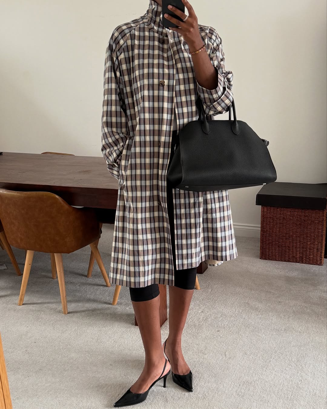 Woman wearing plaid jacket trend fall 2025.