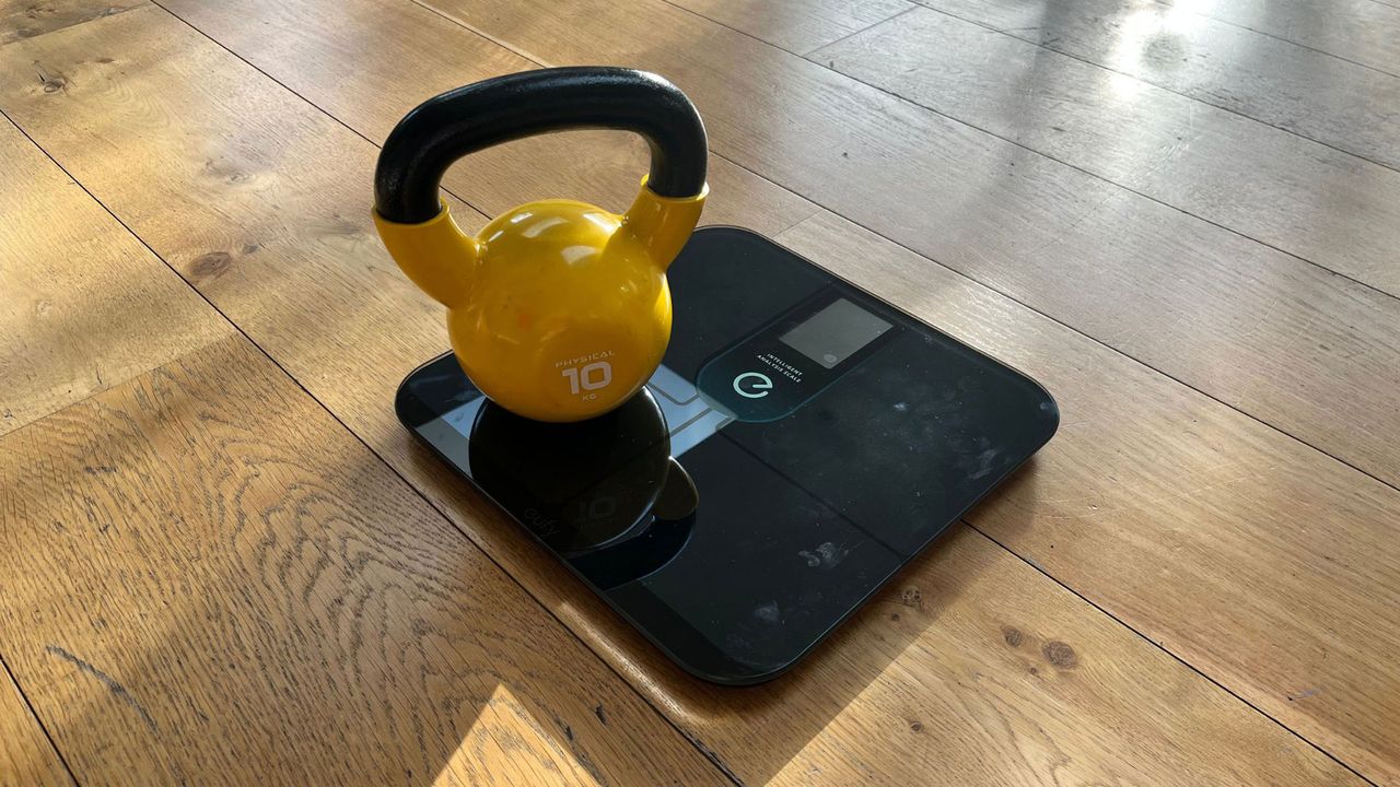 Eufy P3 smart scale weighing a kettlebell
