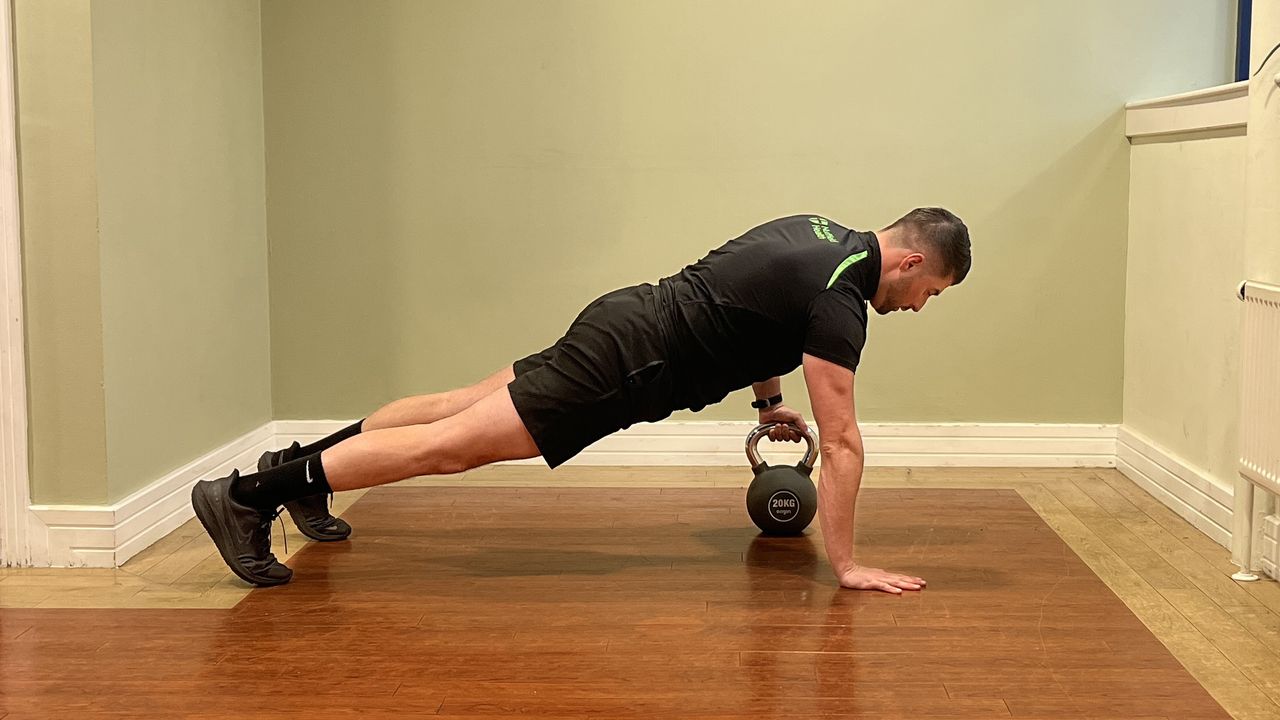 Sam Quinn, strength coach from Nuffield Health, demonstrates a kettlebell pull through
