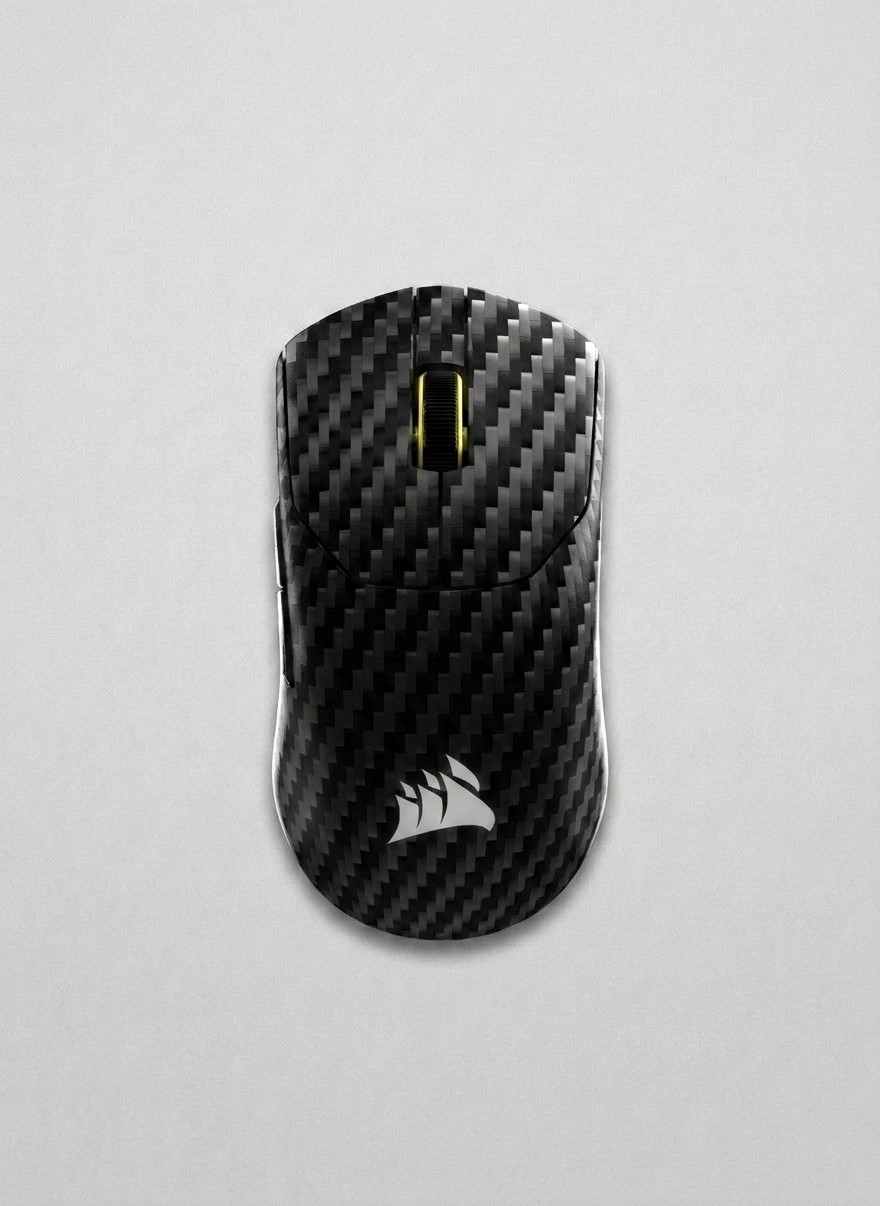 A Corsair Sabre V2 Pro carbon fiber gaming mouse on a grey background