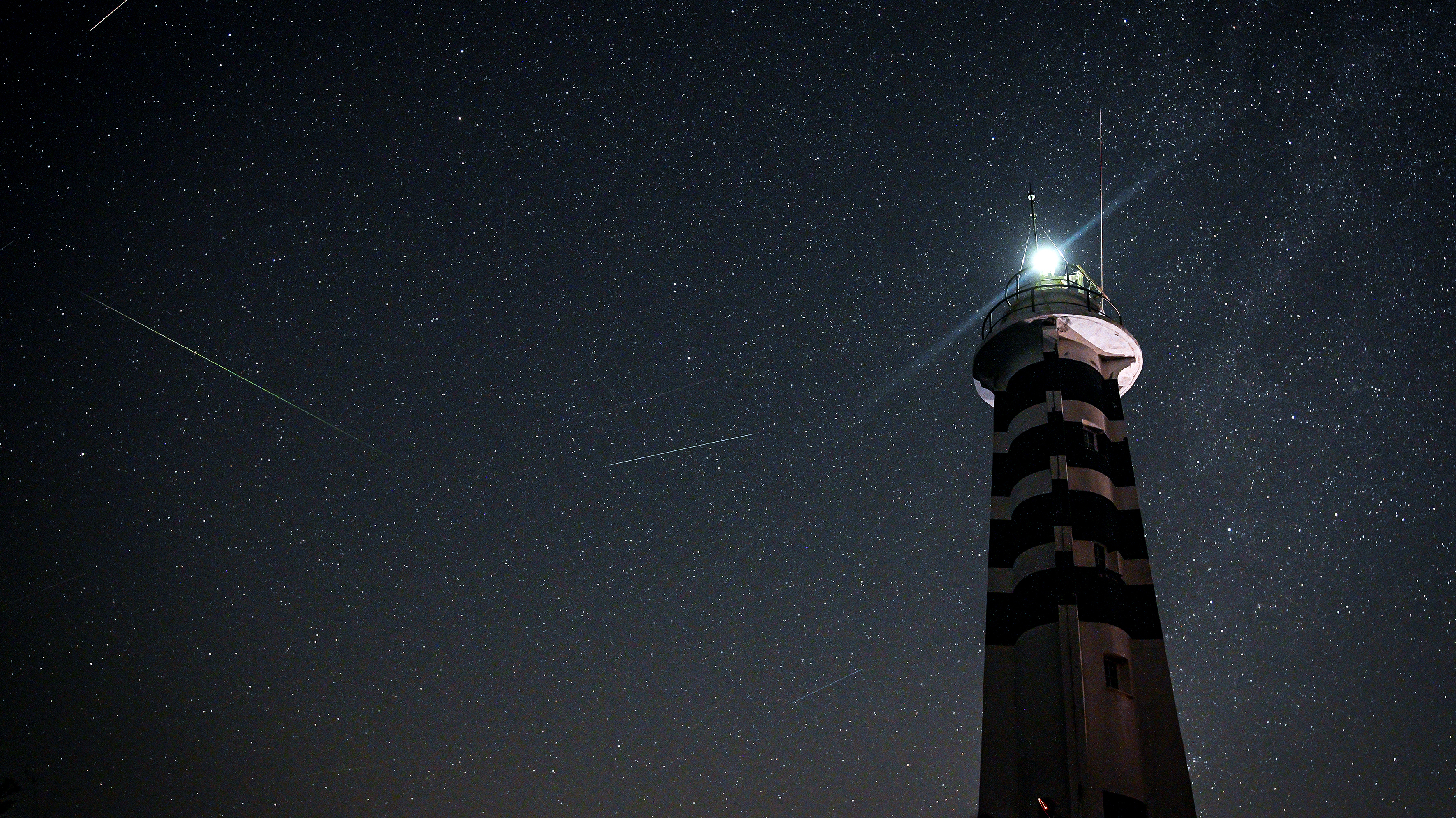 IZMIR, TURKIYE - AUGUST 12: Meteors streak across the night sky during the annual Perseid meteor shower over the Sarpincik Lighthouse in the Karaburun district of Izmir, Turkiye, on August 12, 2026. (Photo by Mahmut Serdar Alakus/Anadolu via Getty Images)