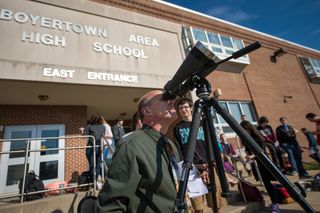 Boyertown Area High School astronomy teacher Peter Detterline prepares high powered binoculars with a solar filter so that his students may view the planet Mercury as it transits across the face of the sun, on May 9, 2016.