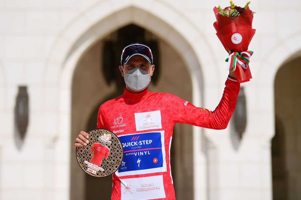 MUSCAT OMAN FEBRUARY 13 Fausto Masnada of Italy and Team QuickStep Alpha Vinyl celebrates winning the Red Leader Jersey on the podium ceremony after the 11th Tour Of Oman 2022 Stage 4 a 1195km stage from Al Sifah to Mucat TourofOman on February 13 2022 in Muscat Oman Photo by Dario BelingheriGetty Images