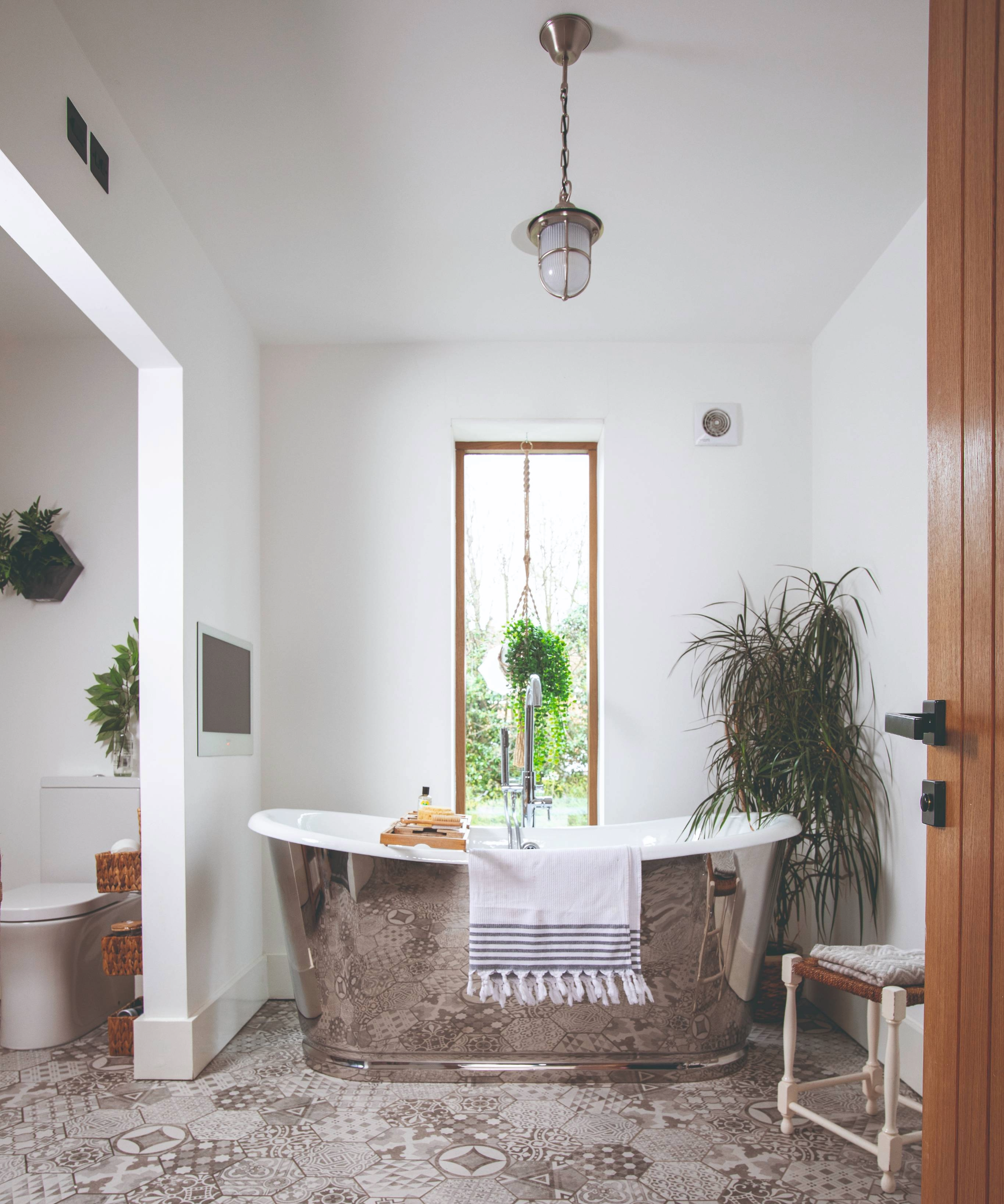 Bathroom with vertical bathroom window idea and silver tub