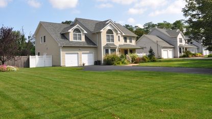 A large suburban home with a large, green front lawn