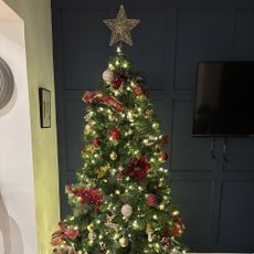 christmas tree with red and gold decorations and a star on the top