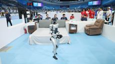 A robot participates in a hotel room cleaning simulation in Beijing in 2025.