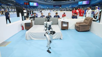 A robot participates in a hotel room cleaning simulation in Beijing in 2025.