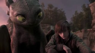 Toothless looking at Hiccup while he draws on the ground in How to Train Your Dragon