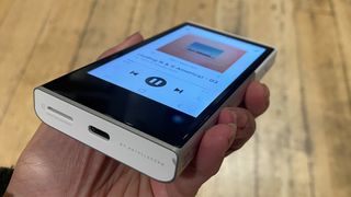 Activo P1 hi-res music player held in hand at angle showing bottom of player