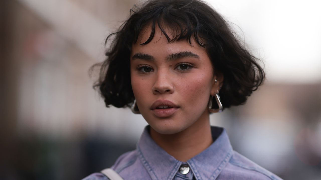 Woman with short brunette French bob and sunkissed dusky blusher