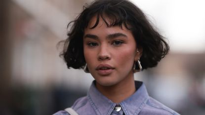 Woman with short brunette French bob and sunkissed dusky blusher