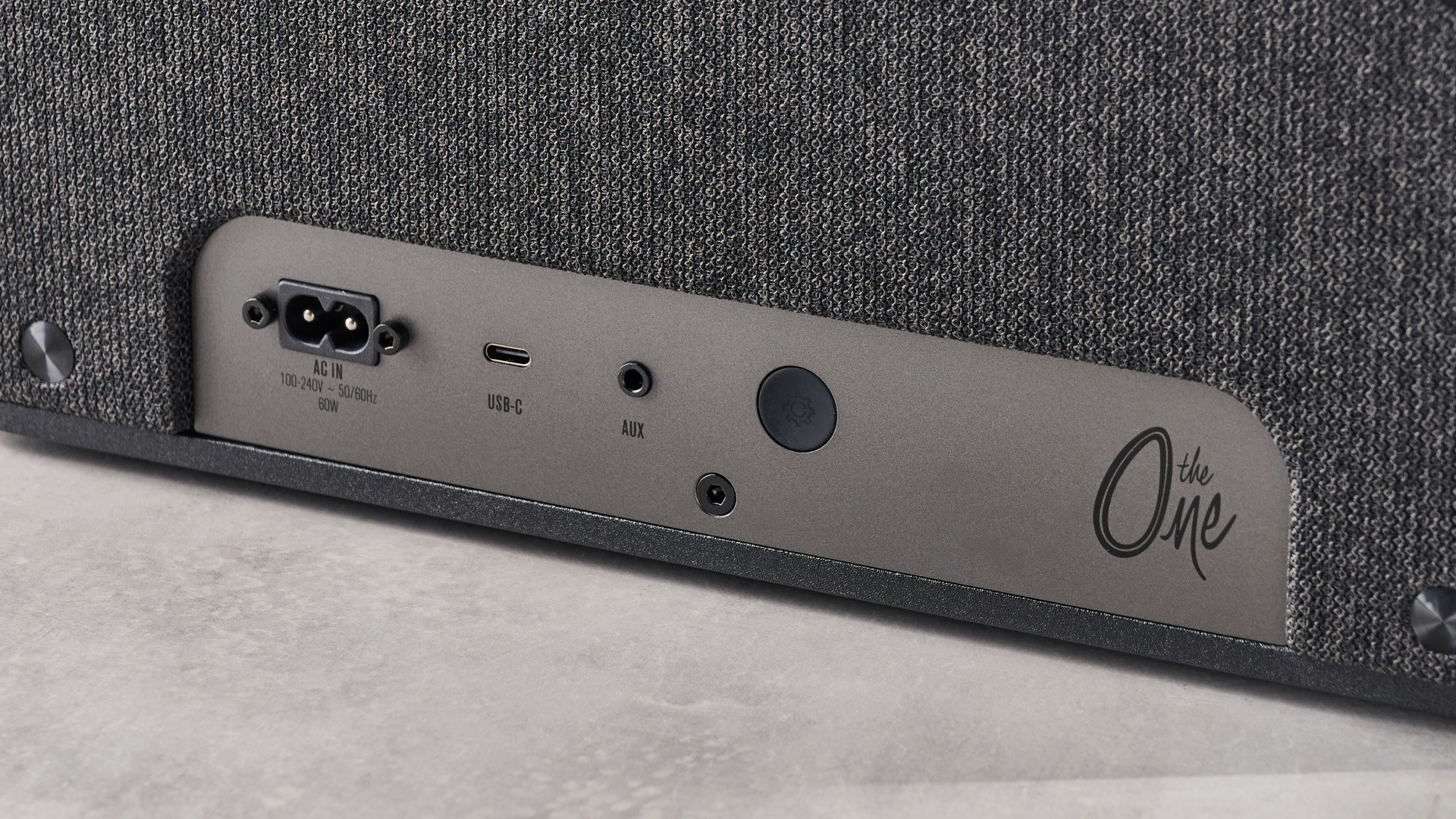 Klipsch The One Plus Bluetooth speaker in matte black photographed in front of a blue background.