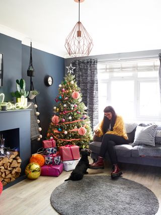 Living room with dark grey walls and christmas tree and decorations