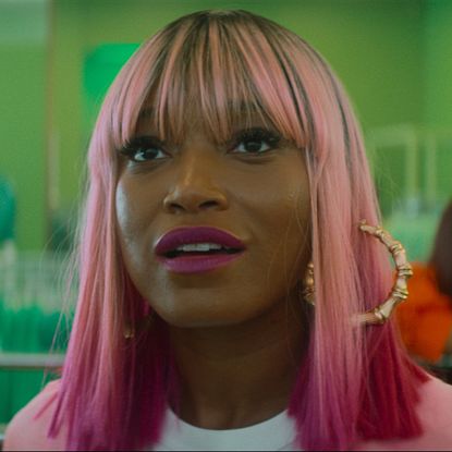 keke palmer with her hair pink and wearing hoop earrings looking awestruck in a still from i love boosters