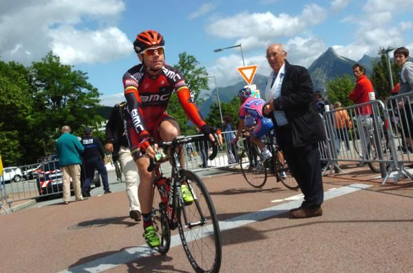 Cadel Evans rides to the start of stage 1