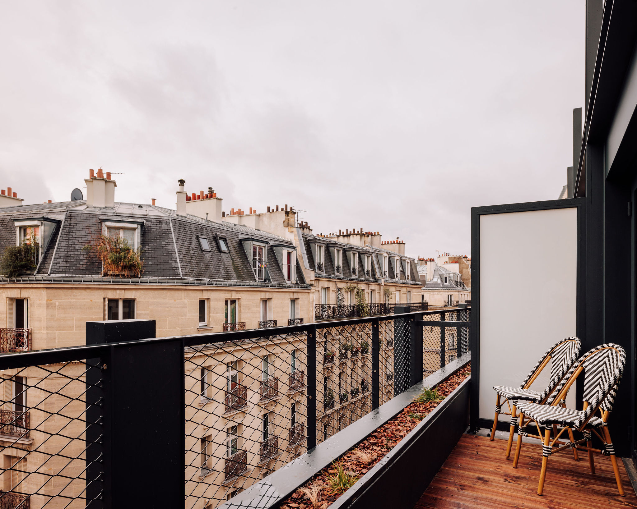 A brightly decorated, patterns and plush textiles-filled hotel's rooms and common spaces feature an earthy palette ranging from ochre and green to terracotta, orange, and brown.