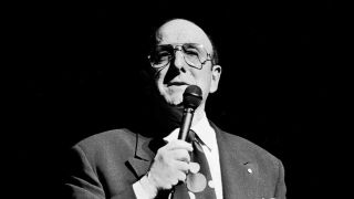 Clive Davis holding a microphone