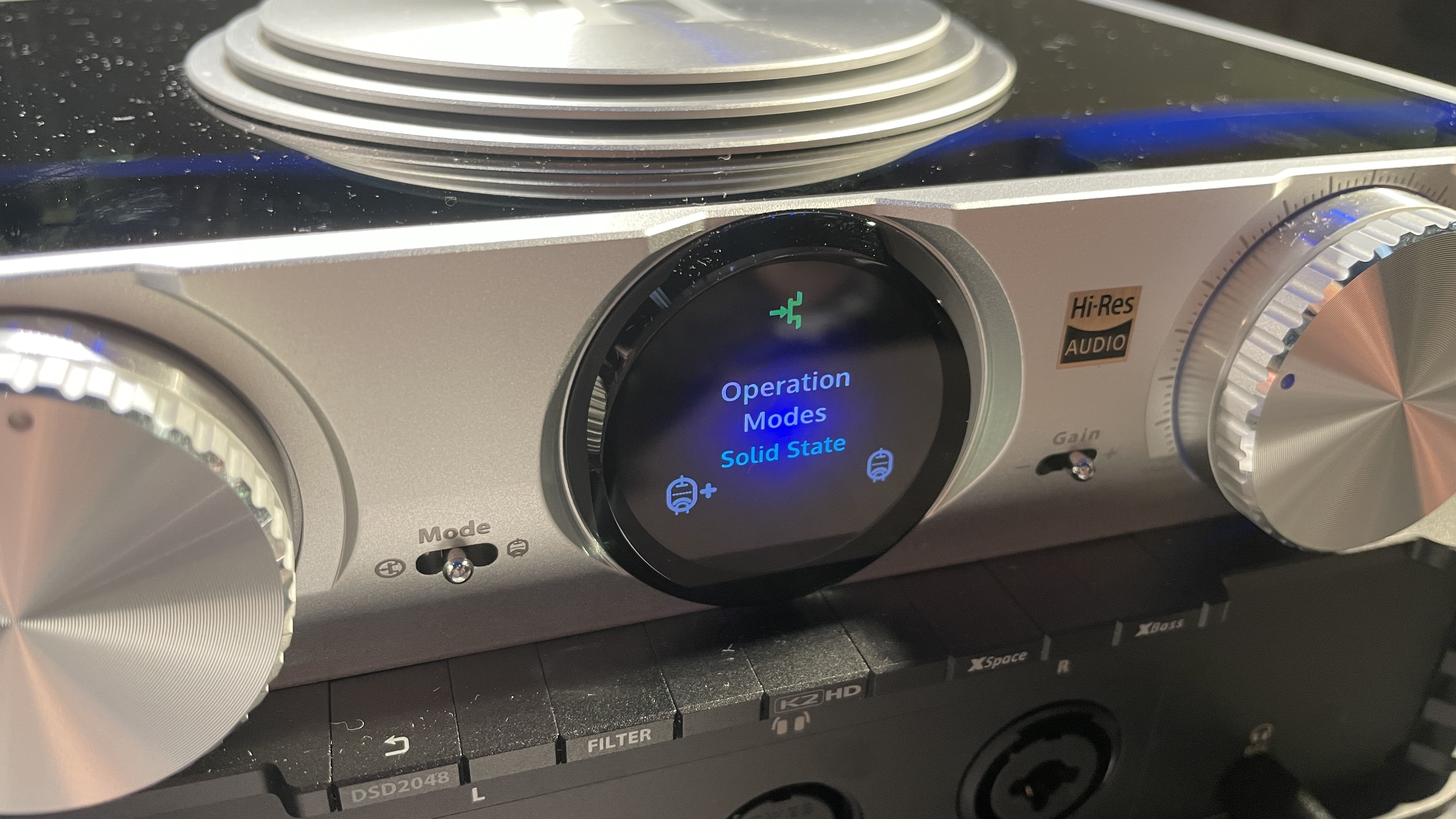 The formidable iFi iDSD Phantom in Tower Bridge, London, used with headphones and illuminating the front panel 