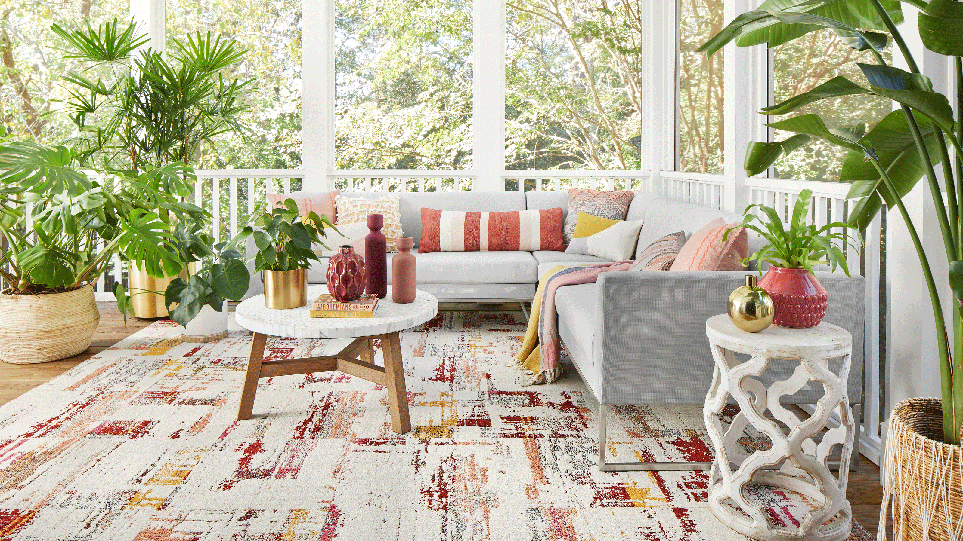 Bright and cheerful seasonal porch with colorful textiles and sociable seating arrangement.