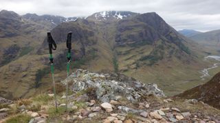 trekking poles and a mountain