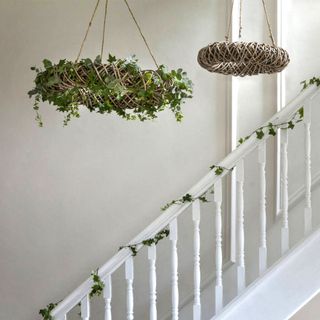 A hanging wreath over a staircase