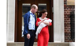 Kate and William on steps holding baby