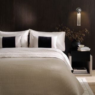 M&S x Kelly Hoppen bedding and decor used in a wood-panelled bedroom