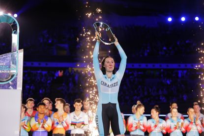 Katie Archibald lifts her winner's trophy at the UCI Track Champions League