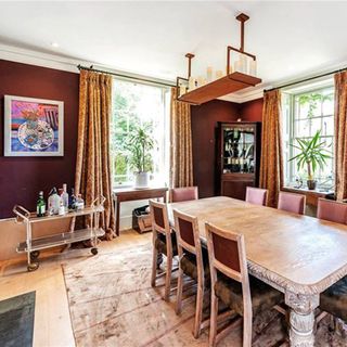 dining room with burgundy wall and dining table