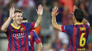 Lionel Messi and Xavi of Barcelona celebrate during the UEFA Champions League match between Barcelona and Ajax at the Cam Nou on September 18, 2013 in Barcelona, Catalonia, Spain.