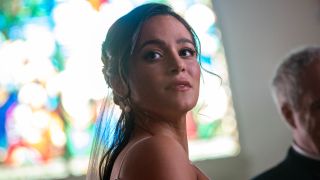 A close up of Stephanie Arcila as Gabriela at her wedding looking out into the crowd. 