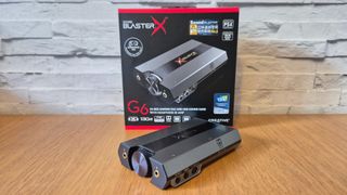 The Creative Sound BlasterX G6 USB sound card on a wooden surface