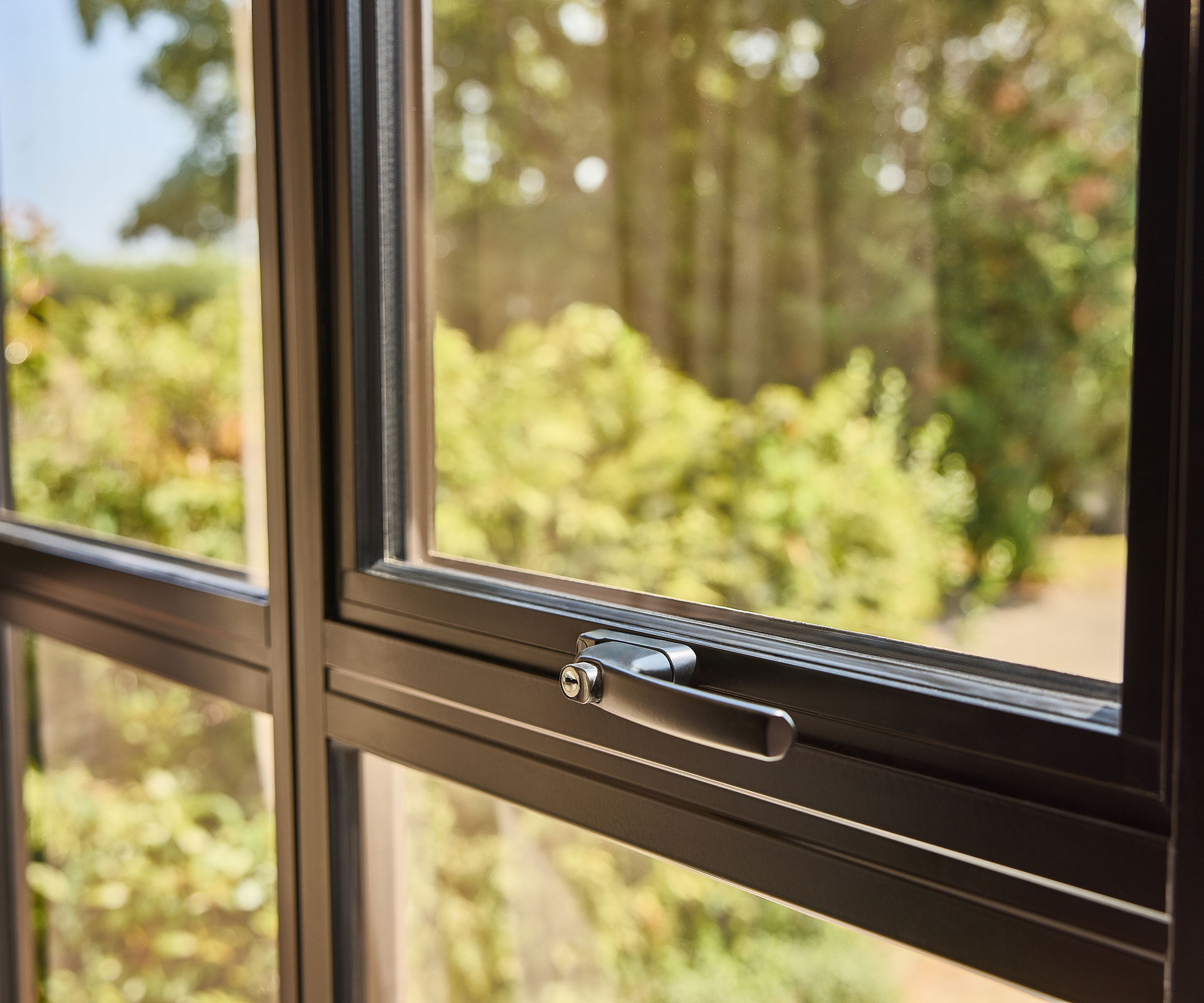 close up of an aluminium window showing the frame and window handle