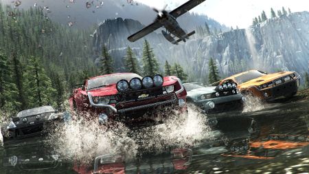 Offroad vehicles race through a shallow stream in The Crew