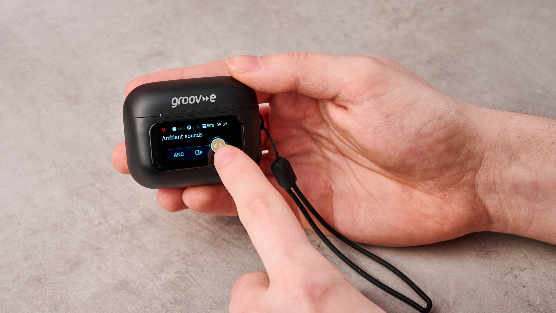 Man adjusting ANC mode on Groov-e Neo Buds