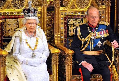 Queen Elizabeth II sits with Prince Philip.