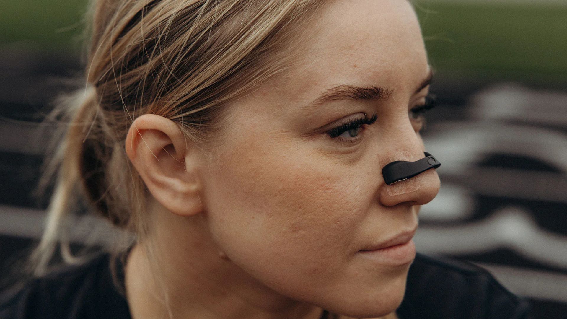 A woman with blonde hair wearing a black Intake Breathing strip