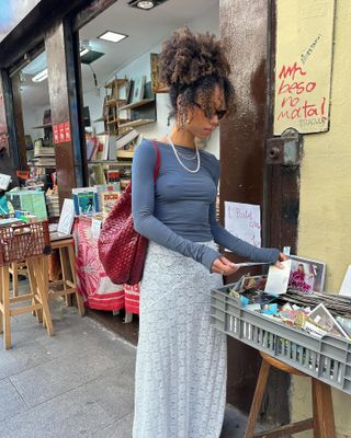 Autumn Microtrends 2024:  @amaka.hamelijnck wears a lace maxi skirt with a jersey long-sleeve top and a red bag