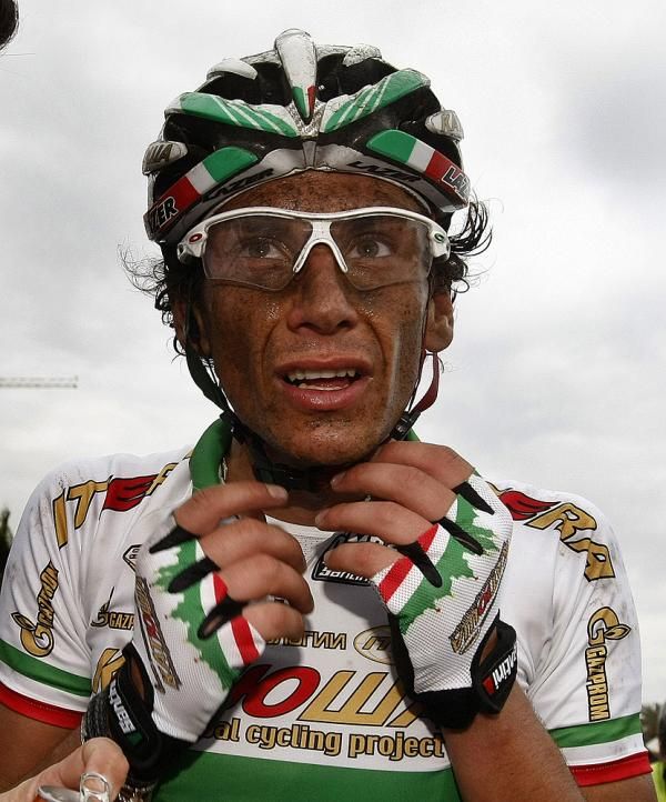 Filippo Pozzato (Katusha) layered in road grime after a tough race.