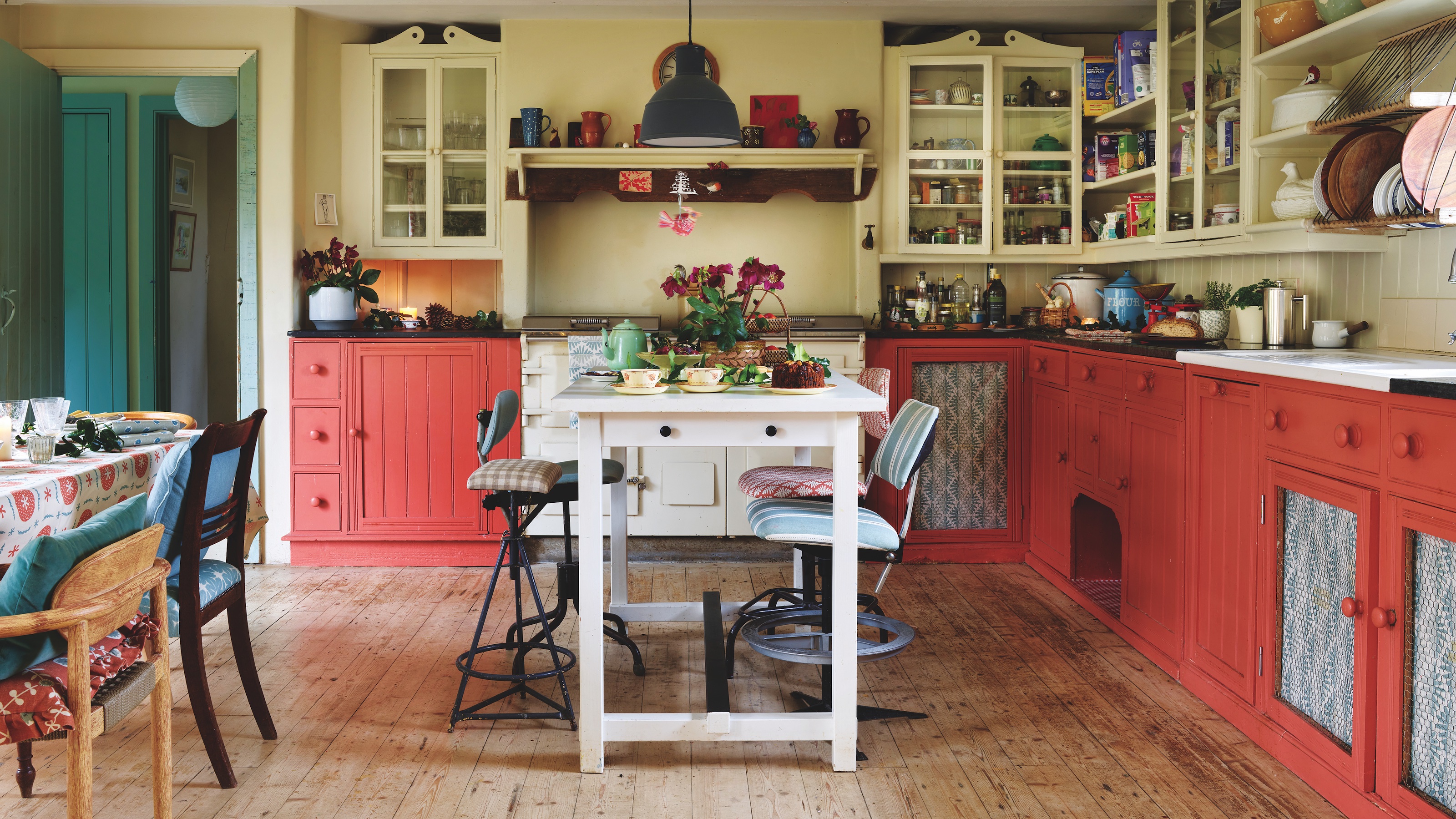 kitchen with peach painted cabinets and white island unit