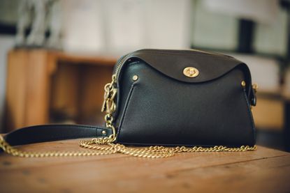 A black purse on a table.